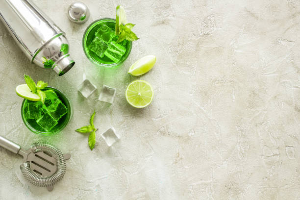 istock Margarita green cocktail with bar tools, lime and mint 1291902804