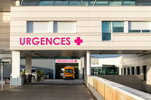 The emergency team rushes the young adult woman on the gurney into a private examination room.