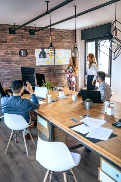 istock Female manager in a work meeting with her workers 1291903646