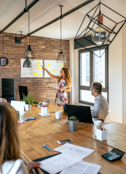 istock Female manager in a work meeting with her workers 1291903648