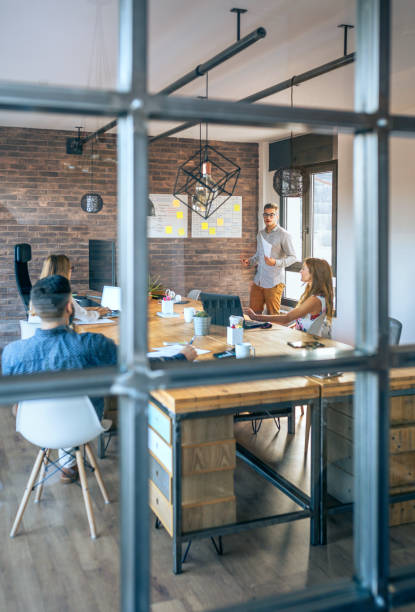 istock Coach giving a talk to workers in an office 1291903669