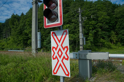 level crossing sign with st. andrew's cross and traffic lights at a railway crossing