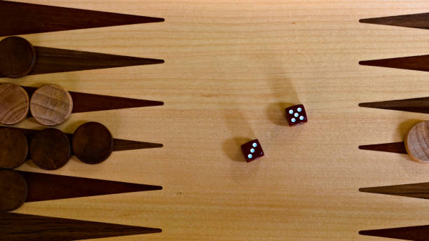 istock Part of a backgammon board with checkers and two dice 1291904668