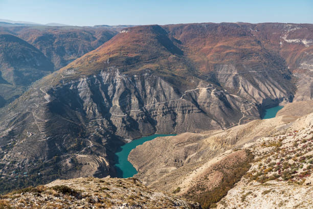 istock Green valley with mountains and azure lakes in canyon 1291905018