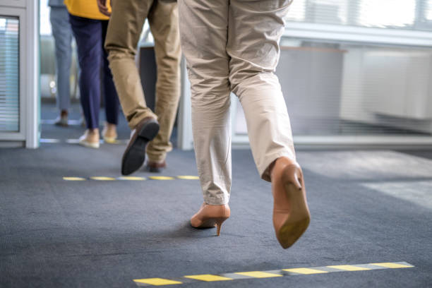 istock Close-up of pairs of legs doing steps in queue 1291905635