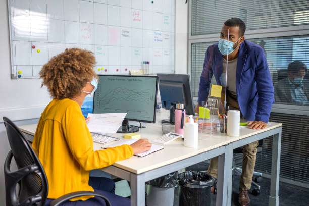 istock Man and woman wearing face mask and talking 1291905651