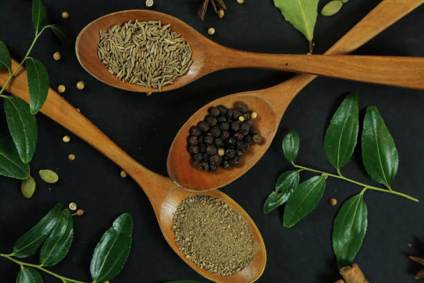 istock Wide variety spices and herbs on background of black table 1291908230
