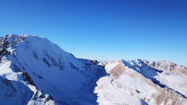 istock High rocks covered with snow. The Tuyuk Su Glacier 1291910374
