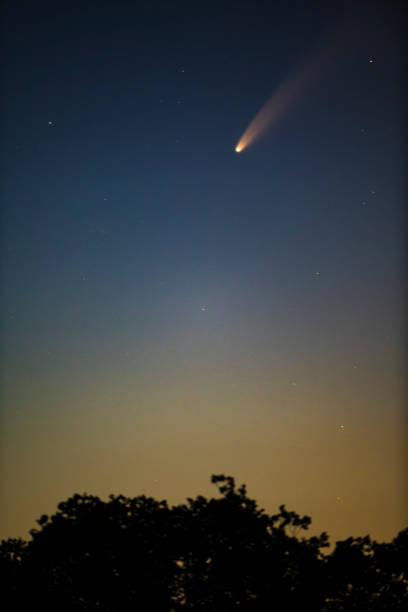 Comet Neowise in the dark night sky Comet Neowise in the dark night sky over The Netherlands on July 10, 2020. The comet is showing a trail meteorite photos stock pictures, royalty-free photos & images