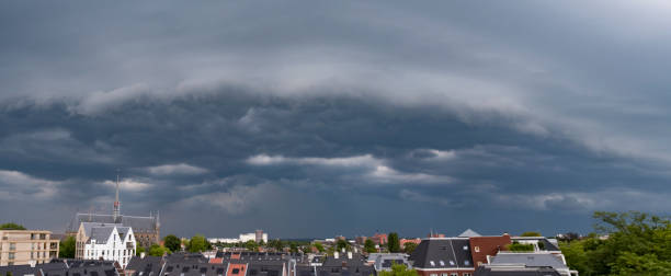 Dark storm clouds in the evening sky during a summer thunderstorm. Light is peaking through the clouds.