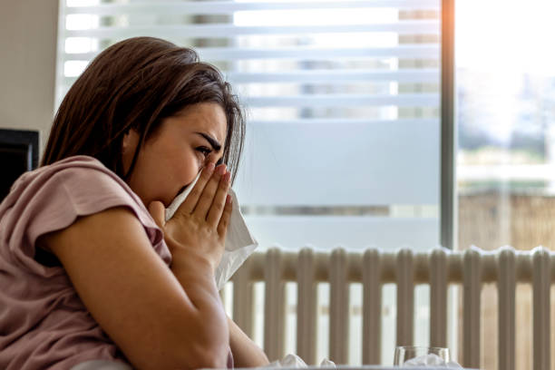 istock Sick young woman at home on the sofa with a cold. 1291915354