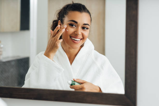 istock Middle east woman applying cream in bathroom mirror 1291916112