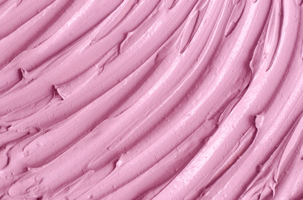 istock Rose cosmetic clay (alginate facial mask, face cream, body wrap) texture close up, selective focus. Abstract background with brush strokes. 1291917732