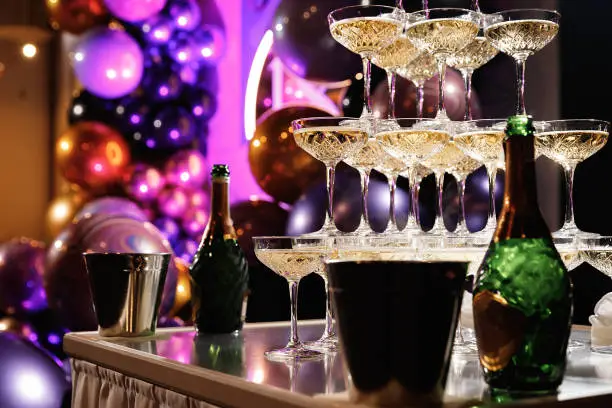 Champagne pyramid for parties at Birthday, party in restaurant. Glasses with champagne in the form of a slide. 2021
