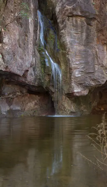 Photo of Gran Canaria, small freshwater pool in Tejeda municipality called Charco de la Paloma, ie Dove Pool water is running after winter rains