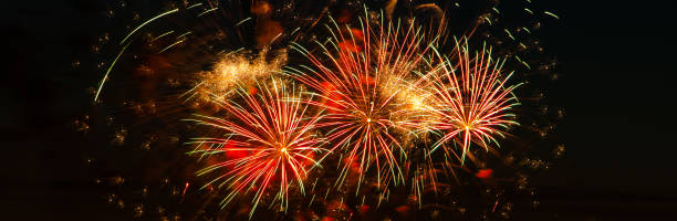 istock Bright colored fireworks on a festive night. Explosions of colored fire in the sky. Banner format 1291918849