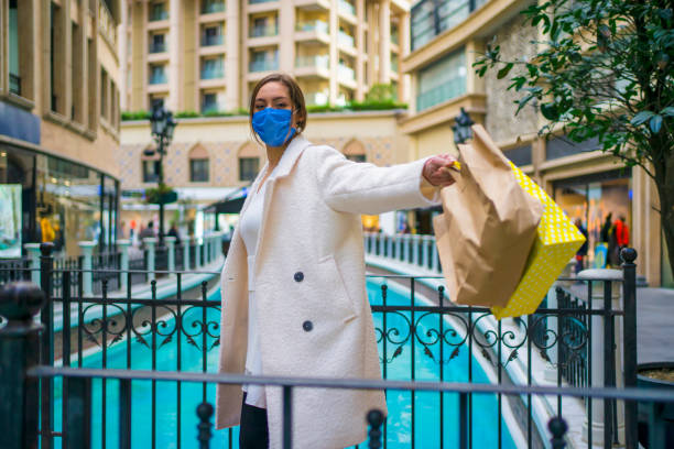 istock Happy shopper wearing face mask 1291919842