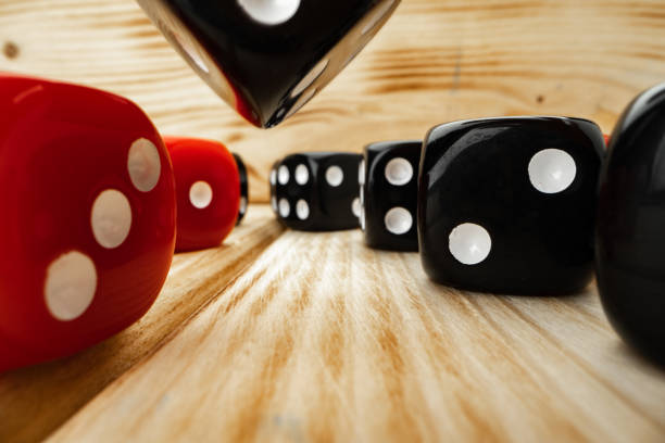 istock Red and black dice cubes on wooden background 1291920712