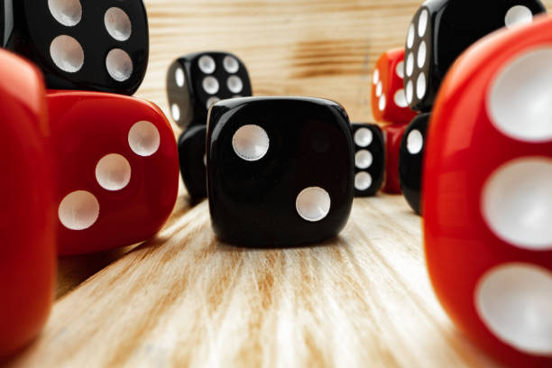istock Red and black dice cubes on wooden background 1291920748