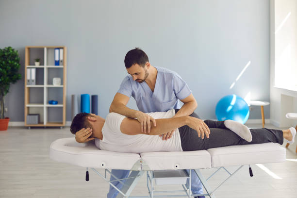 istock Chiropractor, osteopath, physiotherapist or manual therapist helping patient with backache 1291920870