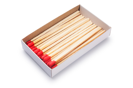 Studio shot of red matches cut out against a white background.