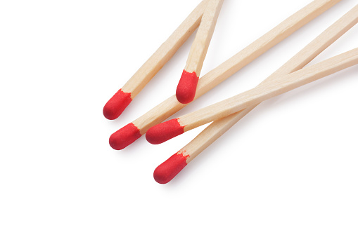 Studio shot of red matches cut out against a white background.
