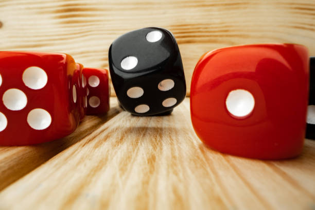 istock Red and black dice cubes on wooden background 1291923102