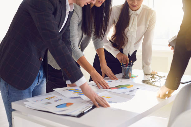istock A group of businessmen are working discussing analyzing a project at a table at the workplace in the office. 1291924153
