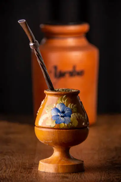 Yerba Mate is a traditional infusión consumed in the countries of Argentina, Paraguay and Uruguay mostly. It is made by soaking dried leaves of the yerba mate plant in hot water. The picture shows one typical container where you serve this drink hot beverage, the container can be made of different materials, in this case it´s made of wood.