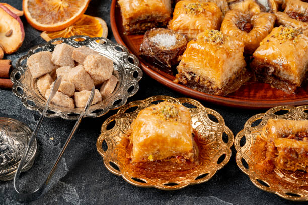 istock Assortment of turkish baklava on black textured surface 1291926799