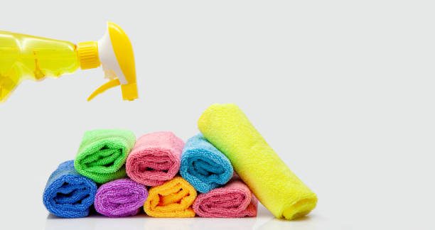 Microfiber cleaning cloth and cleaning spray bottle. colorful microfiber towels isolated. rolled textile cloth, colorful. Domestic household cleaning service and articles concept.