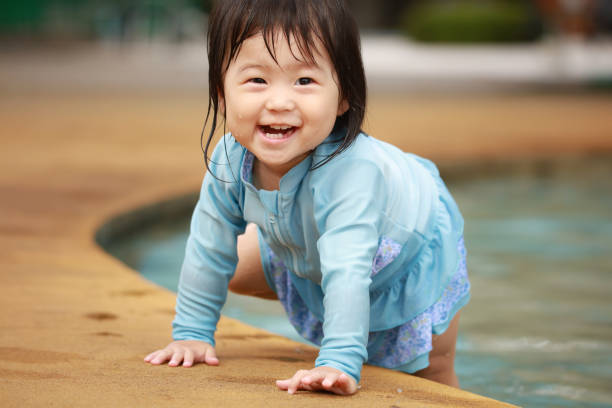 istock Girl playing in the water 1291932475