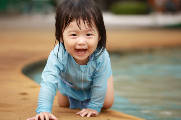 istock Girl playing in the water 1291932522