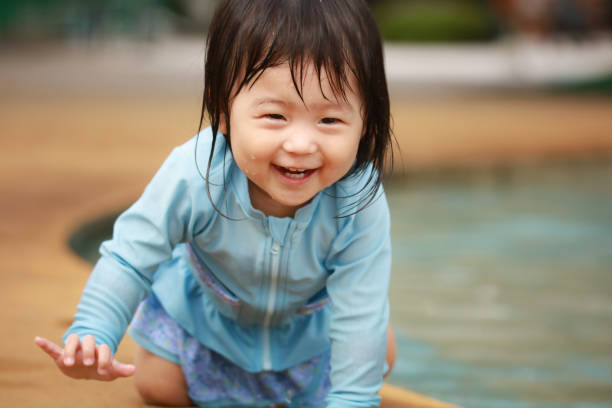 istock Girl playing in the water 1291933385