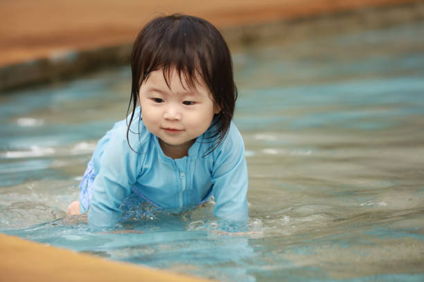 istock Girl playing in the water 1291933967