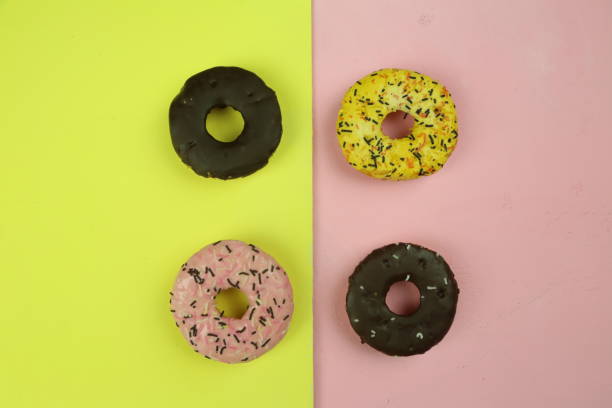 istock sweet donut with colored background 1291935141