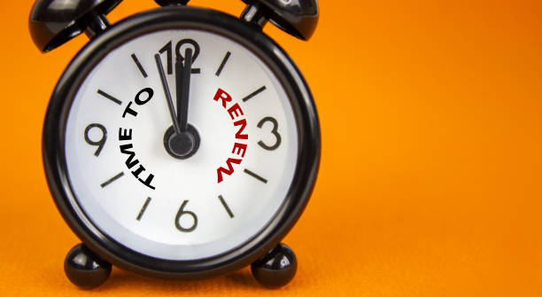 time to renew symbol. beautiful black alarm clock with words 'time to renew'. beautiful orange background. copy space. business and time to renew concept. - clock time alarm clock orange imagens e fotografias de stock