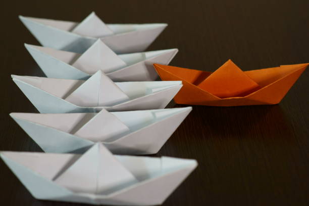 istock Several paper boats on the table. 1291940724