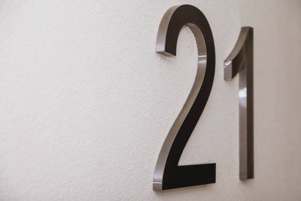 istock Number twenty one on texture light wall, symbolizing year 2021 1291941792
