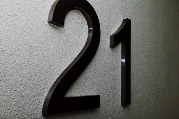 istock Number twenty one on texture light wall, symbolizing year 2021 1291941809