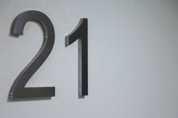 istock Number twenty one on texture light wall, symbolizing year 2021 1291941816
