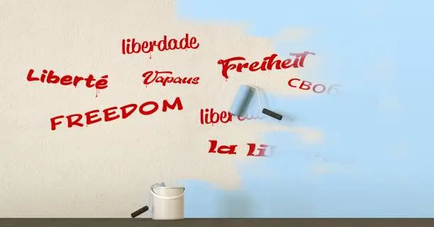 Photo of words freedom written in different languages on a wall covered with paint - 3D rendering