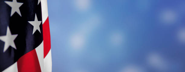 istock American flags border over defocused blue bokeh lights background. Flyer. 1291947657
