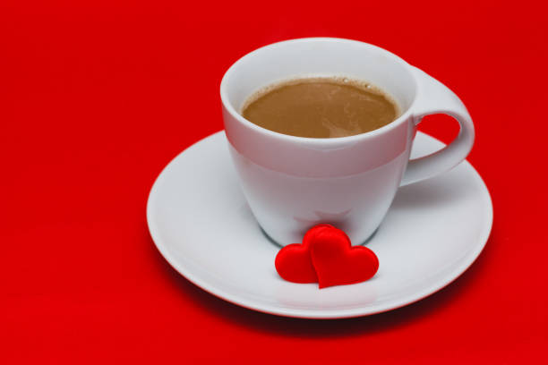 istock Valentine's Day coffee with milk on red background 1291950942