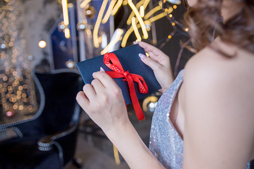 young happy female opening christmas card