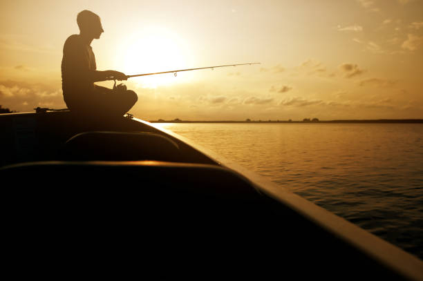 istock Side view of man fishing 1291954471