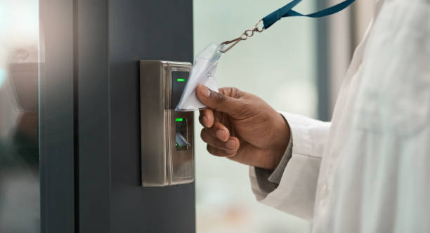 Authorised personnel only Closeup shot of an unrecognisable scientist using an access card to gain entry at a door cardkey stock pictures, royalty-free photos & images