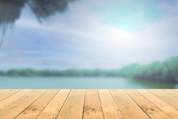 istock Empty wooden board empty table in front of blurred background. 1291959539