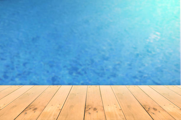 istock Empty wooden board empty table in front of blurred background. 1291959563