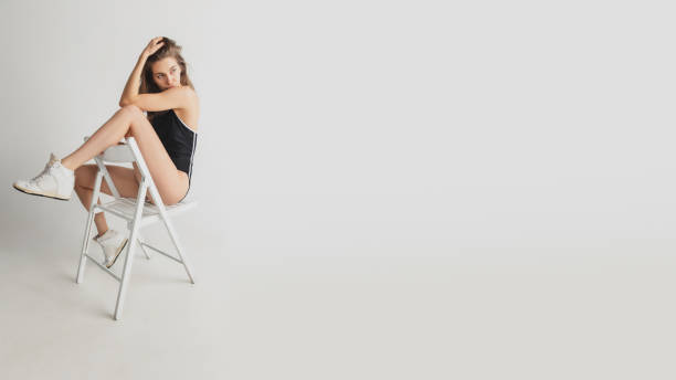 istock Beautiful young woman's portrait isolated on grey studio background. Having fun, happy, full length 1291960553